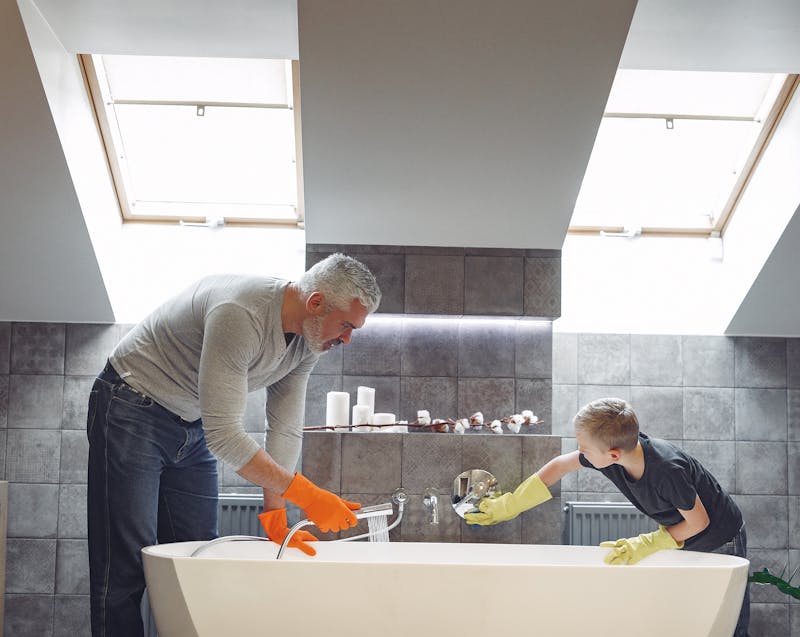 inspecting and cleaning the bathroom plumbing